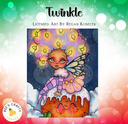 The image is a vibrant illustration featuring a whimsical fairy with a large, colorful headdress and wings, sitting atop a cake with a face drawn on it. The background is a dark blue color with white snowflakes scattered throughout, creating a festive and magical atmosphere.