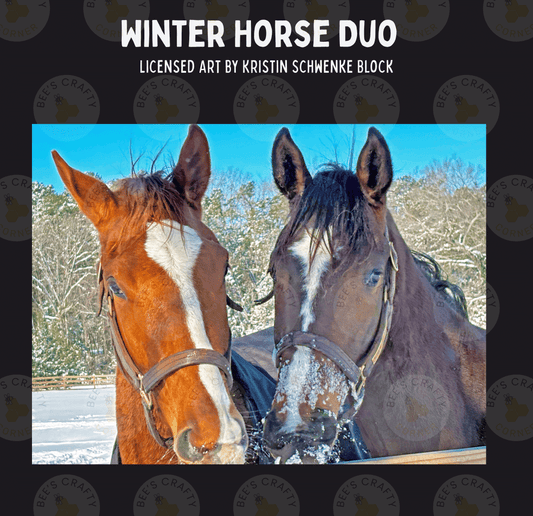 Two horses, one brown and one black, stand together in a snowy field, with the brown horse wearing a bridle and the black horse without a bridle.