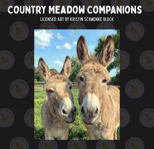Two donkeys standing together in a field, with a blue sky and trees in the background.