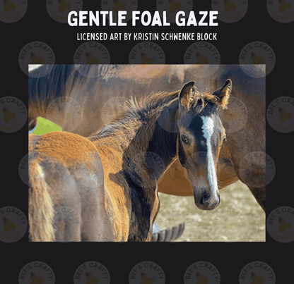 A close-up photograph of a foal's head and neck, with the foal's eyes and ears clearly visible. The background is blurred, drawing attention to the foal.