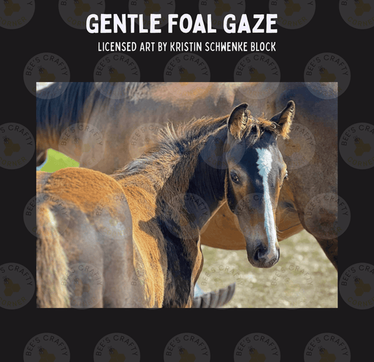 A close-up photograph of a foal's head and neck, with the foal's eyes and ears clearly visible. The background is blurred, drawing attention to the foal.