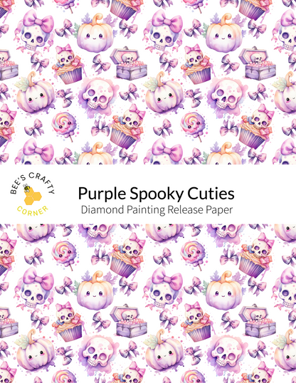 The image is a repeating pattern of various spooky and whimsical illustrations, including skulls, pumpkins, cupcakes, and other Halloween-themed objects. The pattern is predominantly purple and white, with some accents of pink and orange. The text "Purple Spooky Cuties Diamond Painting Release Paper" is displayed in the center of the image, indicating that this is a release paper for a diamond painting kit focused on creating cuties.