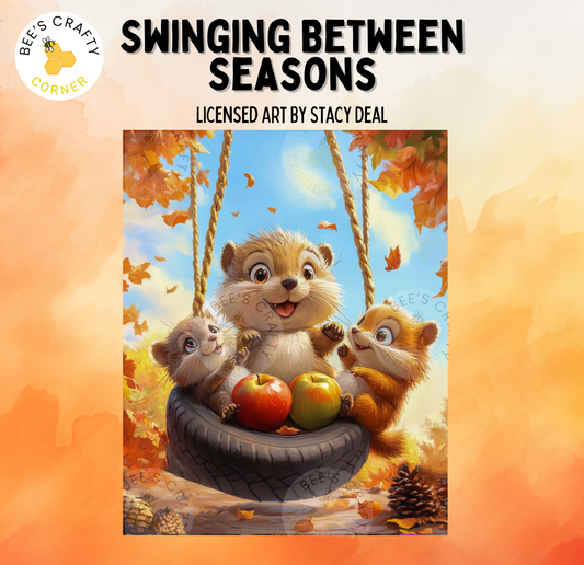 The image is a painting depicting three cartoon animals, including a squirrel, a chipmunk, and a beaver, sitting together in a tire swing surrounded by autumn leaves and apples.